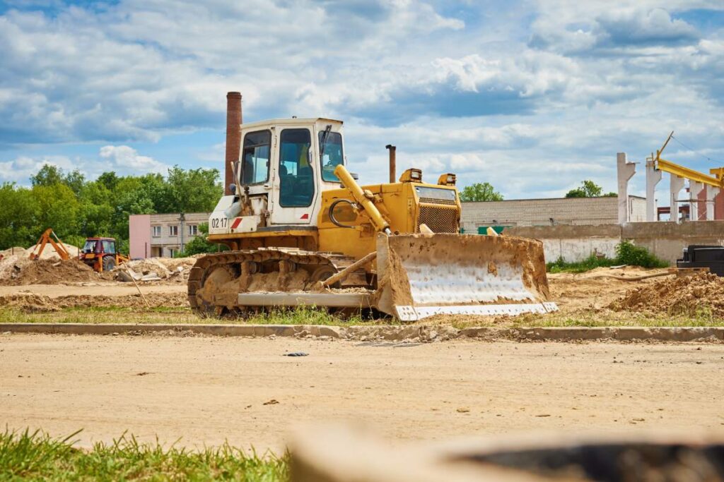 Yellow bulldozer at construction site. Heavy machinery for construction