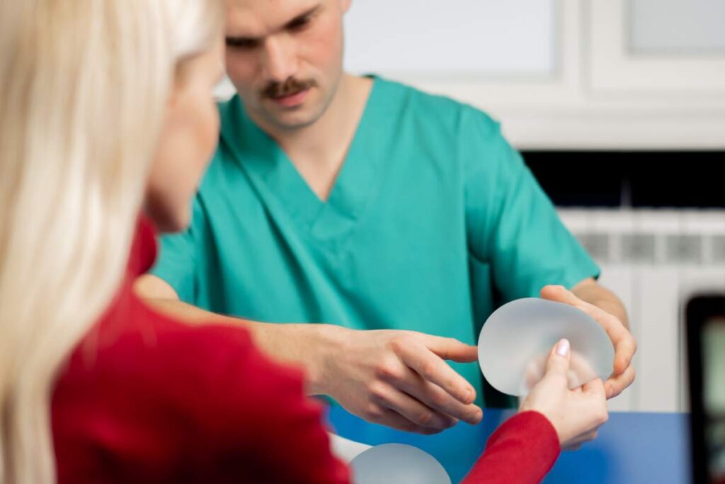 in a plastic surgery clinic a doctor advises a young girl on breast augmentation