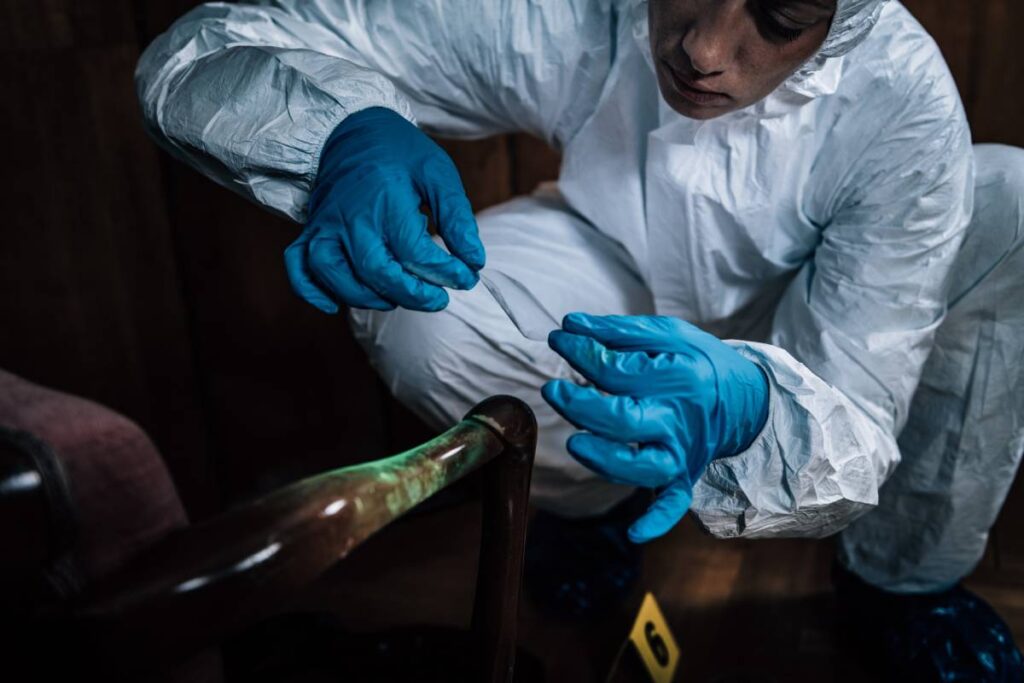 Police Forensic Science Investigator Lifting Fingerprints from a Crime Scene